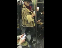 Man kung fu fights with pole inside of subway train