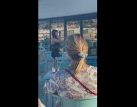 Woman in black outfit while man sits to take picture