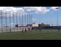 Soccer player in yellow jersey jumps in air to block red player and collides on soccer field