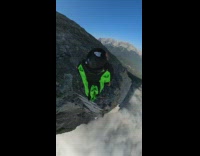 Collab SendItOfficiall - Guy black green wingsuit jumps mountain parachute