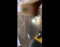 Group of baseball players run out of building roof blown off