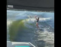 Girl on wakeboard catches her balance boat