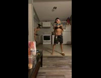 Woman trips while putting on pants trying to record video with friend