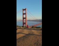 Woman in red dress twirls  on the Bridge Viewpoint