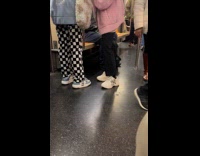 Two train passengers wear Yankees shoes and jacket