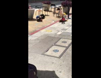 Girl lays on sidewalk curb for photo