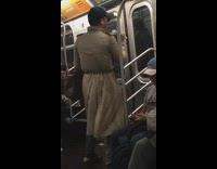man in brown trench coat dancing on subway