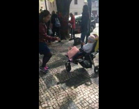 Baby in stroller photographs mom graffiti wall 