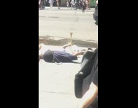 a man in blue playing trumpet on street floor