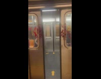 Red paint splattered on subway doors that are closing 
