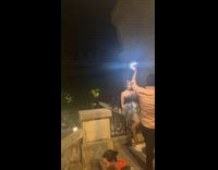 Woman in dress poses  on the grills