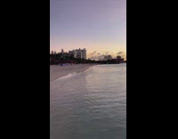 Woman in dress tiktok dance at the beach