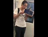 Guy on subway eats cake from box 