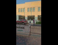 Woman white dress flex behind clothes store window