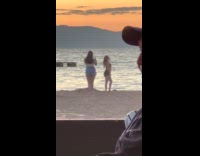 Woman in black bikini photoshoot at beach