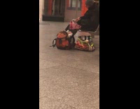 Guy spreads cream cheese on bagel and makes breakfast in subway station