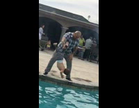 Bald man little boy leg hold over pool