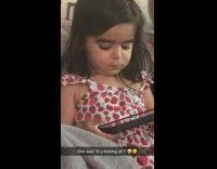 Kid on phone glares at filmer 