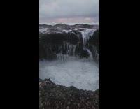 Filmer reached by the large beach waves