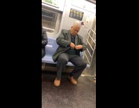 Man clips his fingernails on a subway train