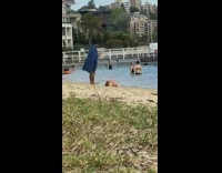 Man pictures woman in bikini lied down on the beach