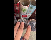 Woman showing thin wrapping paper rolls at Walmart 