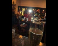 Woman films meal with light at restaurant