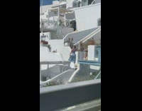 Woman in blue dress models at Santorini