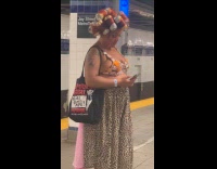 Woman using aluminum cans as hair curlers 