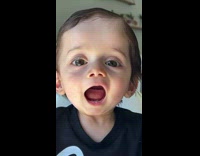 Baby Smiles and Opens Mouth at Camera