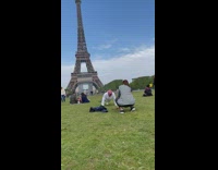 Guy pink hat push ups Eiffel tower