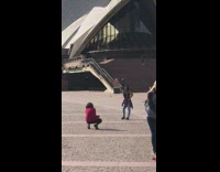 Woman violet jacket wrapped waist sydney opera house