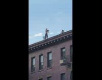 Girl squats dumbbells rooftop edge black leggings