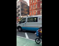Woman ride bicycle in Mickey Mouse costume