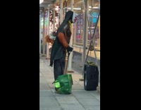Guy on sidewalk exercises with resistance band