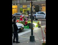 The Grinch waves at people riding car