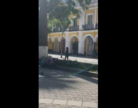 Black tank top girl dances yellow building 