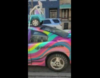 Toy car sits on top of pastel car