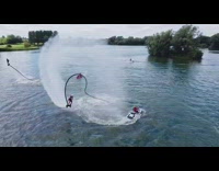 White helmet guy flyboard backflip lake drone
