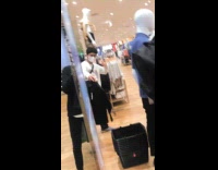 Guy shows friends in shopping store mirror 