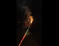 Slow motion stick firecrackers produce sparks night