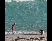Man in briefs and beach hat poses at the beach