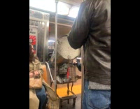 Guy pulls tank on cart rides subway