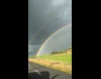 Man appreciating beauty of double rainbow