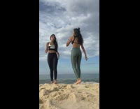 2 ladies try to film video on beach but phone almost gets caught by wave 