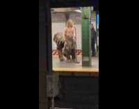 Centaur man holds microphone at subway station