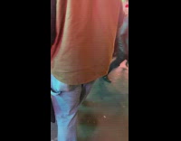 Man walks on busy sidewalk with gold shoe cane 