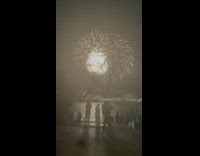 Man watch fireworks display at night in pier 15 new york 