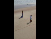 Woman tan backless purple dress beach bird