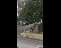 Woman green jacket stomp feet dance sidewalk
